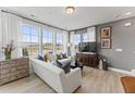 Sun-drenched living room featuring stylish decor and large windows at 1230 Coach Station Alley # 101, Raleigh, NC 27601