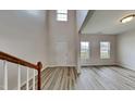 Inviting entryway with soaring ceilings, a staircase, and hardwood floors that create an open and airy atmosphere at 128 Chownings Dr, Sanford, NC 27330