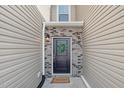 Inviting front entry featuring a classic black door, brick accents, and a welcoming wreath at 131 Explorer Dr # 257, Morrisville, NC 27560