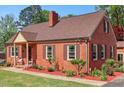 Lovely brick home with neat landscaping and a cozy front porch at 132 Lord Ashley Rd, Raleigh, NC 27610