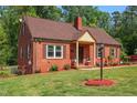 Beautiful red brick home with a cozy front porch and well-maintained landscaping at 132 Lord Ashley Rd, Raleigh, NC 27610