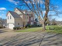 A view of the side of the house and driveway showcasing a charming home exterior at 132 Mantle Dr, Clayton, NC 27527
