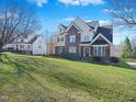 Charming two-story home with brick accents, a well-kept lawn, and mature trees at 132 Mantle Dr, Clayton, NC 27527