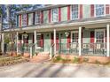 Lovely home exterior showcasing a quaint front porch with hanging plants and inviting decor at 1408 Hunters Point Way, Cary, NC 27511