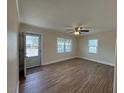 Bright living room featuring hardwood floors, a ceiling fan, and natural light at 1421 Deer Crossing Ct, Henderson, NC 27536