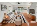 Bright living room with large windows, neutral decor, and hardwood floors at 1501 Copper Cir, Mebane, NC 27302