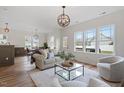 Bright living room features hardwood floors, recessed lights, neutral paint, and a cozy seating arrangement at 153 N Farm Dr, Clayton, NC 27527