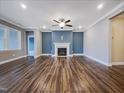 Bright living room with fireplace, ceiling fan, and hardwood flooring at 157 Auburn Village Blvd, Raleigh, NC 27610