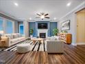 Bright living room with fireplace, ceiling fan, and stylish striped rug at 157 Auburn Village Blvd, Raleigh, NC 27610