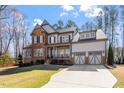 Charming two-story home with a 2-car garage and a beautifully landscaped front yard at 1705 Yates Pond Way, Raleigh, NC 27606