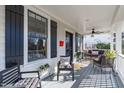 Relaxing front porch with comfortable seating, ceiling fan, and stylish decor at 202 Duncan St, Raleigh, NC 27608
