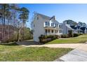 Lovely exterior view of the home with a side entry garage, driveway, and grassy yard at 213 Yellow Poplar Ave, Wake Forest, NC 27587