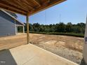 View from the patio of the home showcasing the backyard and the surrounding wooded area at 251 Meadowbark Bnd # 30, Garner, NC 27529