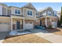Inviting townhome featuring brick accents, a single car garage, and neutral color palette at 2822 Casona Way, Raleigh, NC 27616