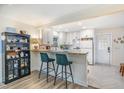 Bright and airy kitchen featuring white cabinets, butcher block counters, and breakfast bar at 2968 Tram Rd, Fuquay Varina, NC 27526