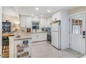 Modern kitchen with white subway tile backsplash, white appliances, and herringbone tile floor at 2968 Tram Rd, Fuquay Varina, NC 27526