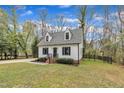 Inviting two-story home with a manicured lawn and iron decorative fence at 305 Dickens Rd, Fuquay Varina, NC 27526