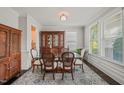 Bright dining room boasts natural light with large windows, traditional furnishings and decorative rug at 309 Orange Blossom Ct, Wake Forest, NC 27587