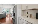 Modern kitchen featuring stainless steel appliances, white cabinets, and stylish countertops at 309 Orange Blossom Ct, Wake Forest, NC 27587