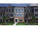 Rendering of a modern townhome with brick accents, gray siding, and well-manicured landscaping at 340 Chesapeak Commons St # 139, Garner, NC 27529