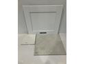 Sample board showcasing white kitchen cabinet door, countertop, and flooring materials at 340 Chesapeak Commons St # 139, Garner, NC 27529