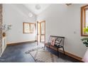 Bright entryway features slate floors, wood trim, bench with decorative pillows, and backyard view at 380 Wesley Ct, Chapel Hill, NC 27516