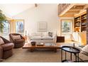 Cozy living room with vaulted ceilings, exposed beams, two comfortable armchairs, and modern decor at 380 Wesley Ct, Chapel Hill, NC 27516