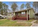 Lovely single-story home with a covered porch with detailed woodwork and brick accents at 402 Abbott Dr, Sanford, NC 27330
