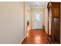 Warm and inviting entryway with gleaming hardwood floors and a decorative front door at 463 Kerriann Ln, Clayton, NC 27520