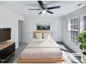 Cozy bedroom featuring a ceiling fan, natural light, and neutral decor at 4842 Wyatt Brook Way, Raleigh, NC 27609