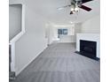 Bright living room with a fireplace and modern ceiling fan, creating a welcoming space at 4842 Wyatt Brook Way, Raleigh, NC 27609