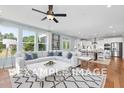 Spacious living room featuring a large sectional sofa, decorative rug, and expansive windows with neighborhood views at 5036 Trotter Dr, Raleigh, NC 27603