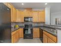 Functional kitchen with wood cabinetry, modern appliances, and tile backsplash at 534 Ives Ct, Chapel Hill, NC 27514