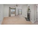 Bright living room featuring neutral walls, carpet flooring, fireplace, and large windows at 534 Ives Ct, Chapel Hill, NC 27514