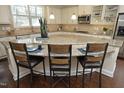 Spacious kitchen with an expansive island, granite countertops, and seating for three at 5421 Downton Grove Ct, Fuquay Varina, NC 27526