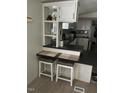 Eat-in kitchen bar with seating for two, with open access to the adjacent kitchen and dining area at 55 Waters Edge Loop, Henderson, NC 27537