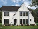 Charming exterior elevation featuring a white brick facade, black windows, and manicured landscaping at 68 Alex Farm Ct # 23, Zebulon, NC 27597