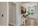 Inviting foyer with natural light, decorative console table, and pristine hardwood floors at 69 Alex Farm Ct # 21, Zebulon, NC 27597