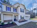 Beautiful two-story home with a covered porch, gray shutters, and manicured landscaping at 69 Azul Dr, Clayton, NC 27520