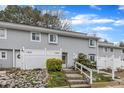 Exterior view of townhome with a front entrance surrounded by rocks and low shrubs at 7305 Sandy Creek Dr, Raleigh, NC 27615