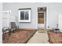 Charming front entrance with a brick patio, seating and light grey siding at 7305 Sandy Creek Dr, Raleigh, NC 27615