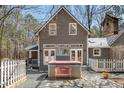 Backyard featuring a hot tub, gravel patio, and wooded views at 9501 Coachway, Chapel Hill, NC 27516