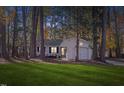 Well-maintained home surrounded by mature trees and lush green lawn creating a serene and inviting atmosphere at 1001 Atchison Street St, Garner, NC 27529