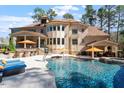 Inviting backyard oasis with a sparkling pool, lounge chairs, and outdoor bar at 1001 Welch Ln, Raleigh, NC 27614