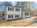 Attractive home boasts a combination of painted brick and vinyl siding with dark shutters and landscaping at 1004 Helms Pl, Raleigh, NC 27610