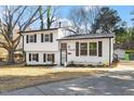 Inviting two-story house with a fresh white exterior, dark shutters, and a neatly paved driveway at 1004 Helms Pl, Raleigh, NC 27610