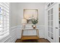 Stylish foyer decor with modern art piece, table lamp, and matching console table at 1013 Manchaca Loop, Apex, NC 27539