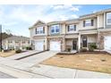 Inviting townhome with stone accents, attached garages, well-kept lawns, and beautiful architectural details at 1019 Navigon Dr, Durham, NC 27713