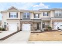 Charming townhome featuring a stone facade, attached garage, well-maintained landscaping, and inviting curb appeal at 1019 Navigon Dr, Durham, NC 27713