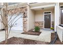 Charming front entrance with stone accents, manicured landscaping, and a welcoming, covered entryway at 1019 Navigon Dr, Durham, NC 27713